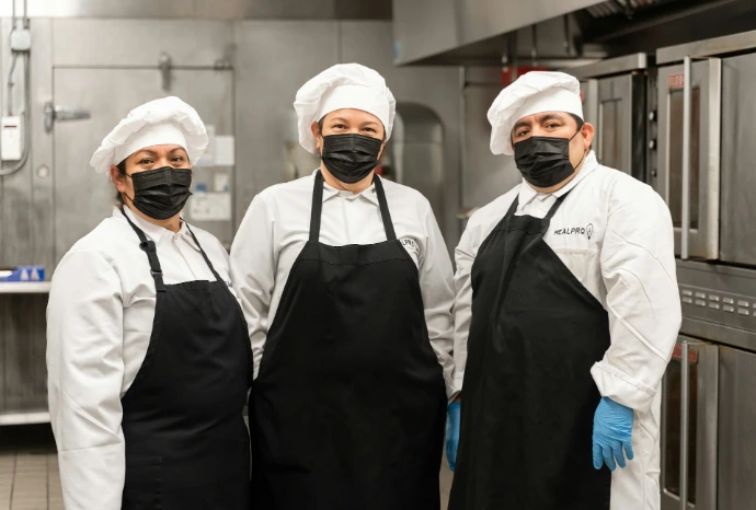 2 men in white chef uniform standing